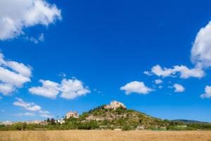 a castle on top of a hill with a blue sky at Pep Not 47 in Artá