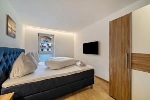 a bedroom with a bed with a blue head board at Ferienwohnung Lamm 2 in San Valentino alla Muta