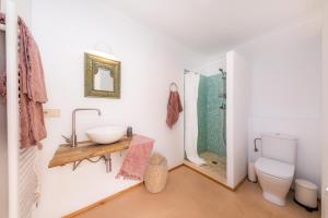 a bathroom with a sink and a toilet and a mirror at Pep Not 47 in Artá +17 photos