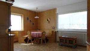a dining room with a table and chairs at La Capinera Canazei Apartments in Canazei