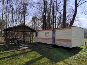a mobile home with a gazebo in a yard at Horyna - Camp Pod kastany in Morávka