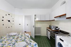 a kitchen with a sink and a table in a room at Casa Alizia in Ospedaletti +12 photos
