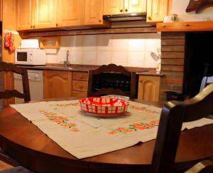 a kitchen with a table with a bowl on it at Casa Es De Bernat 2 in Garós +2 photos