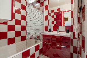 a red and white bathroom with a sink and a tub at Métamorphose Au Sommet in Villard-de-Lans +15 photos