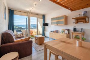 a living room with a couch and a table at Métamorphose Au Sommet in Villard-de-Lans