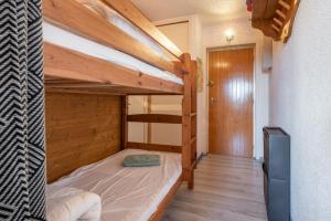 a bedroom with a bunk bed in a room at Métamorphose Au Sommet in Villard-de-Lans