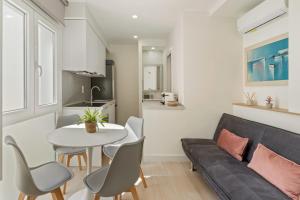 a living room with a couch and a table at Cala Luna-few steps from the beach in La Cala de Mijas