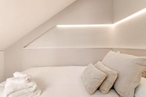 a bedroom with a bed with white sheets and a window at Cala Luna-few steps from the beach in La Cala de Mijas