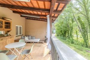 a patio with a table and chairs on a deck at Cal Manyà in Susqueda