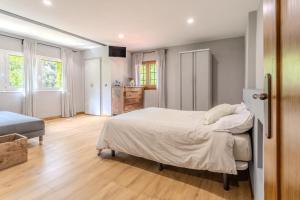 a bedroom with a large bed and a wooden floor at Cal Manyà in Susqueda