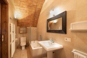 a bathroom with a sink and a toilet and a mirror at Volta De Ferreres in Olvan +26 photos