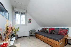a living room with a bed and a couch at Logement Rieux À 6 Km De Redon in Rieux
