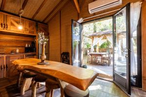 a kitchen with a wooden table and a sliding glass door at Chalet Bangli in Lacanau