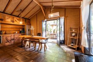 a large kitchen with a wooden table and chairs at Chalet Bangli in Lacanau +18 photos