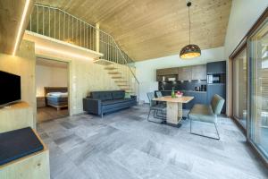 a living room with a table and a couch at Pixnerhof Chalet Bonita in Kastelbell-Tschars