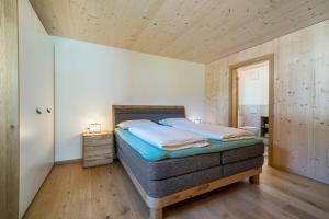 a bedroom with a bed in a room at Pixnerhof Chalet Bonita in Kastelbell-Tschars