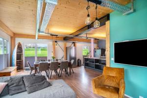 a living room with a couch and a table at Moselbude Cube mit Sauna in Traben-Trarbach
