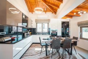 a dining room with a table and chairs in a kitchen at Villa Despina in Rhodes Town