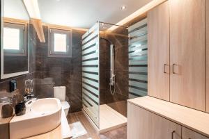 a bathroom with a sink and a shower at Villa Despina in Rhodes Town +16 photos