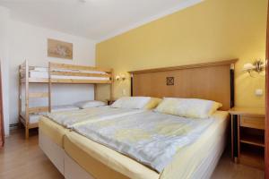 a bedroom with a bed and a bunk bed at Ferienwohnung oberhalb vom Hafen 1 in Sassnitz