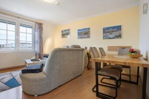 a living room with a couch and a table at Ferienwohnung oberhalb vom Hafen 1 in Sassnitz