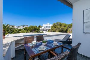 a table and chairs on the balcony of a house at Beach Apartment 11 in Cala d´Or