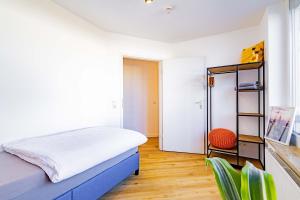 a bedroom with a bed and a chair at Kim Fewo 4 in Emmendingen