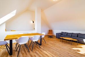 a dining room with a table and a couch at Kim Fewo 4 in Emmendingen