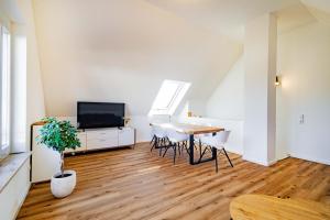 a living room with a table and a tv at Kim Fewo 4 in Emmendingen