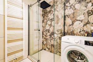 a bathroom with a washing machine in a shower at Kim Fewo 4 in Emmendingen +9 photos