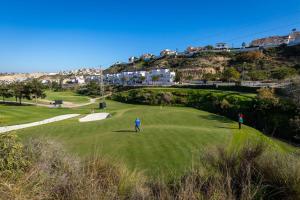 a group of people playing golf on a green at Fidalsa Golf Beach in Ciudad Quesada