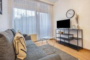 a living room with a couch and a tv at Fewo Das Spatzennest in Bad Harzburg