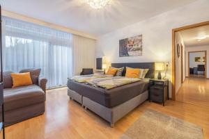 a bedroom with a bed and a couch at Fewo Das Spatzennest in Bad Harzburg +24 photos