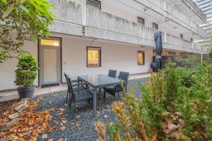 a patio with a table and chairs in front of a building at Fewo Das Spatzennest in Bad Harzburg