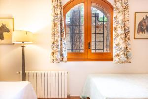 a room with two beds and a window at Ca la Irene II in Begur