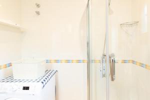 a bathroom with a shower with a basketball hoop at Ca la Irene II in Begur +12 photos