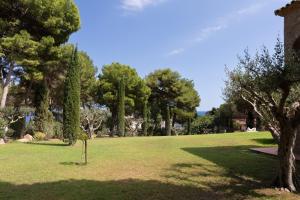 a park with trees and a grass field at Ca la Irene II in Begur