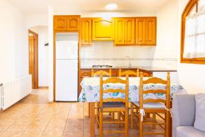 a kitchen and dining room with a table and chairs at Ca la Irene II in Begur