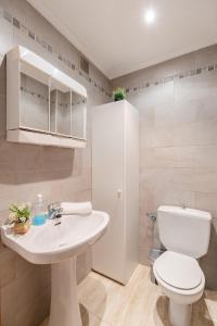 a white bathroom with a toilet and a sink at Fidalsa Bay View Romance in Guardamar del Segura +16 photos