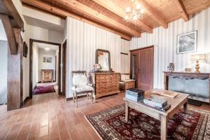 a living room with a table and a mirror at Séjour dans ferme de 1876 in Marignier