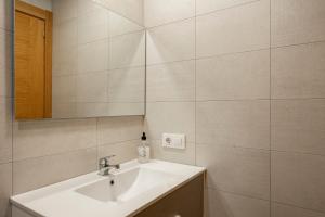 a bathroom with a sink and a mirror at 2 Jardin 1 - Toró in Llanes +18 photos