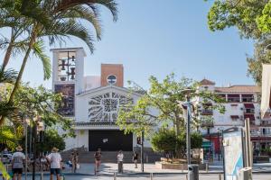 a group of people walking in front of a building at Torre Playa in Torre del Mar
