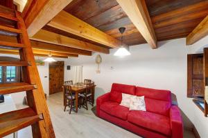 a living room with a red couch and a table at Maison Core' in Fontainamore