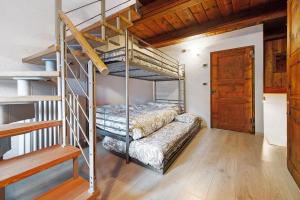 a bedroom with two bunk beds and a staircase at Maison Core' in Fontainamore