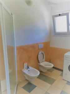 a bathroom with a toilet and a sink at Casa Pito Pito in Alghero +21 photos