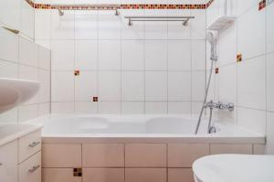 a white bathroom with a tub and a toilet at Ferienwohnung Schmälzle in Braunlage +34 photos