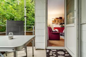 a living room with a table and a glass door at Ferienwohnung Schmälzle in Braunlage