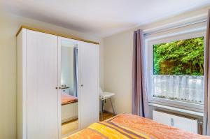 a bedroom with a bed and a window at Ferienwohnung Schmälzle in Braunlage