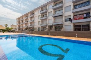 a swimming pool in front of a building at Omega 7 in L'Estartit