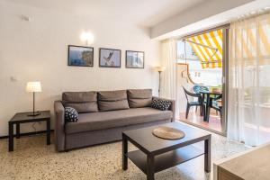 a living room with a couch and a table at Omega 7 in L'Estartit